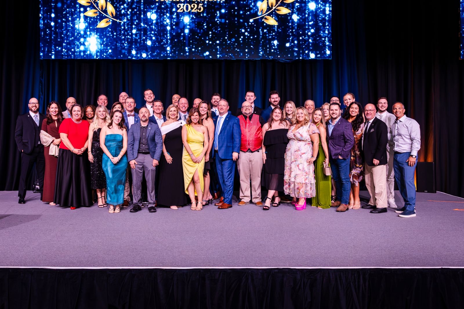Floor Coverings International corporate team gathered on stage