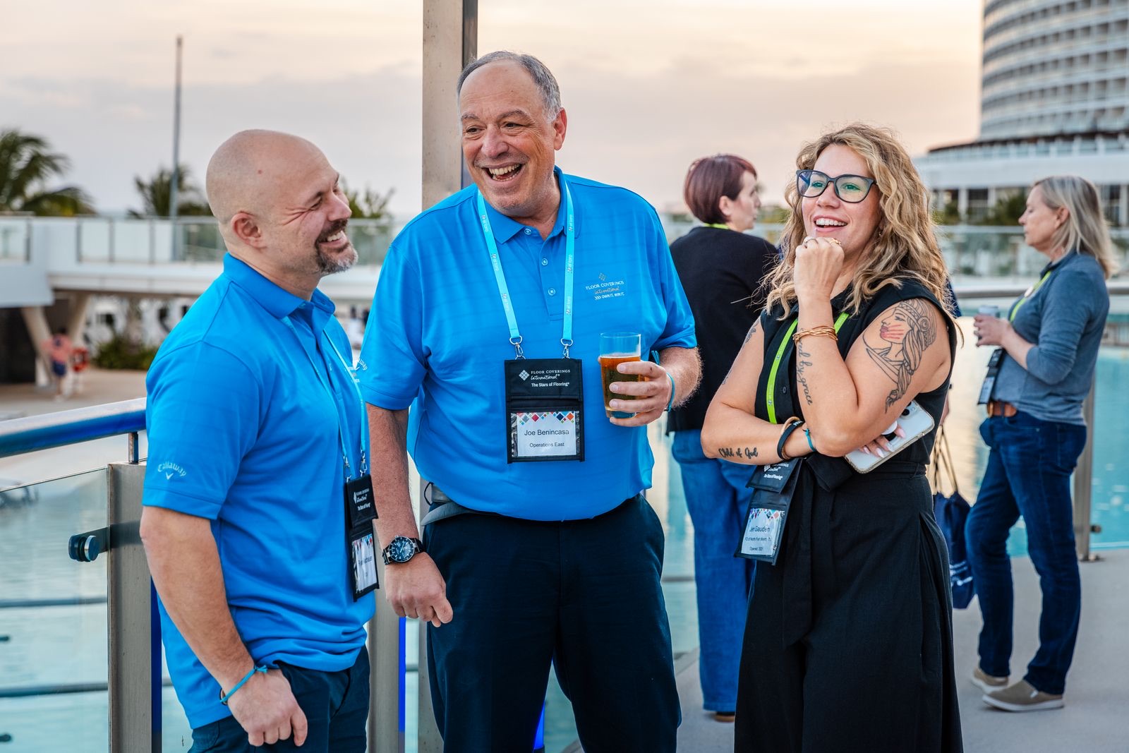 Convention attendees laughing together at an evening reception