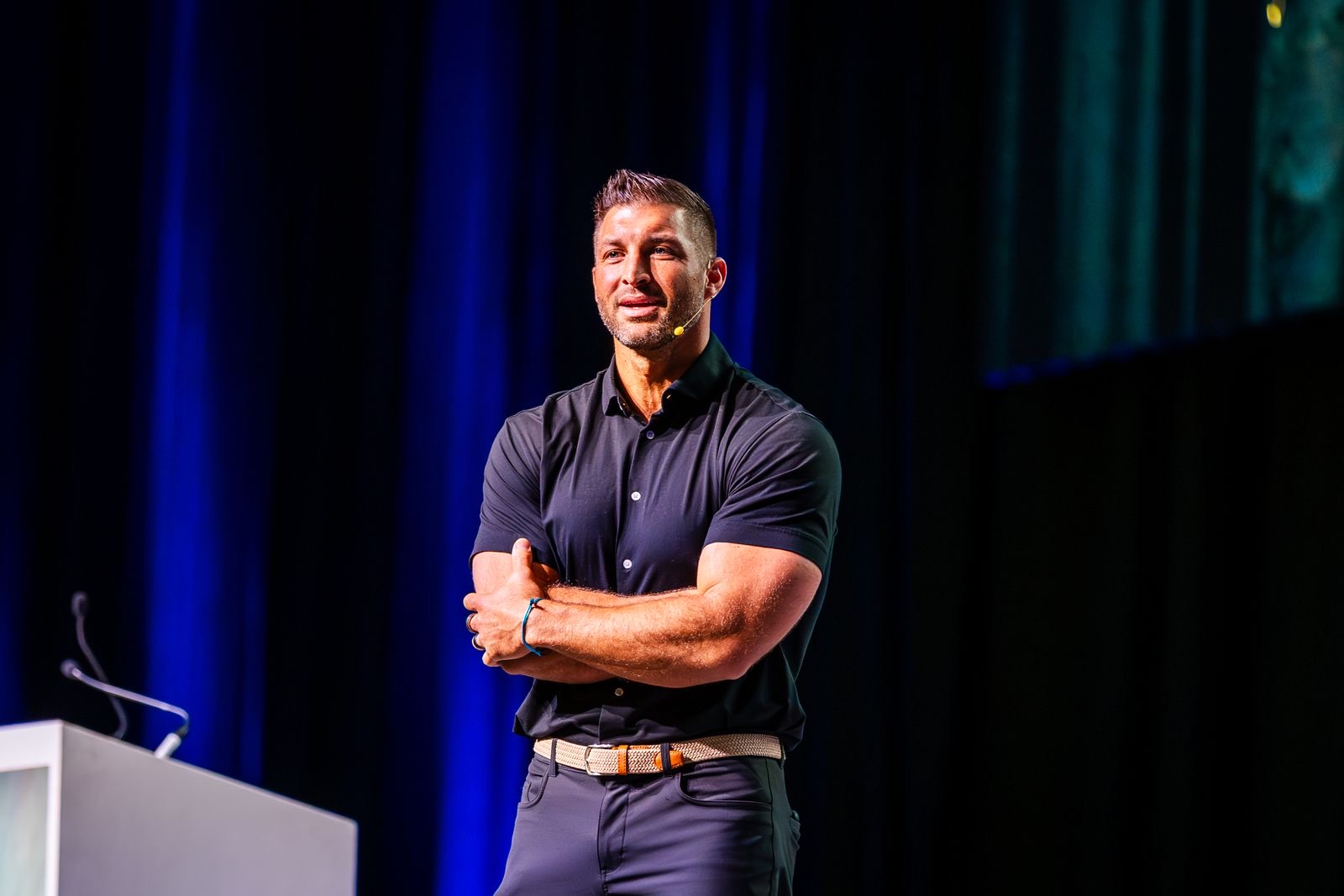 Speaker presenting on stage during a convention main session